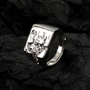 Lava texture silver square ring for women on black volcanic rock background