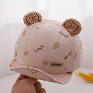 Close-up of soft pink cotton baby hat featuring cute 3D bear ears and printed patterns