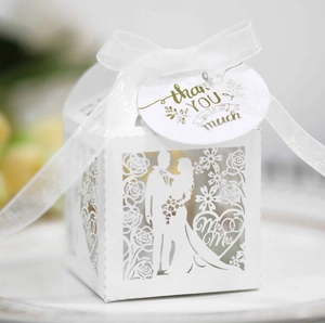 Detail of white laser-cut wedding candy box with Mr & Mrs design and thank you tag