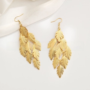 Detailed close-up of layered metal leaf tassels with 18k gold plating on long earrings