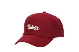 Detail of white vintage embroidery on dark red cotton twill outdoor baseball cap