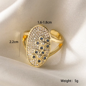 Detailed view of gold plated flower ring with blue zircon and adjustable open band