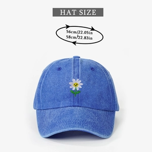 Detail of adjustable washed denim baseball cap with daisy smile embroidery and hat size guide