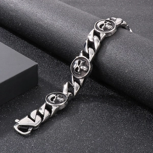 Macro shot of Cuban link chain with detailed skull charms in retro gothic steel style