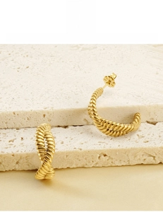 Detailed view of 18K gold-plated C-shape twist earrings showing hypoallergenic plating detail
