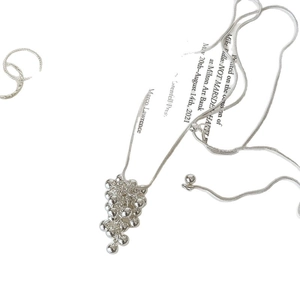 Silver snake chain necklace featuring a modern grape cluster bead pendant on white background