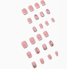 Detail view of French short square press-on nails with silver heart patterns and lines