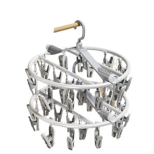 Dual-tier round drying rack with multi-clips for socks and laundry on white background