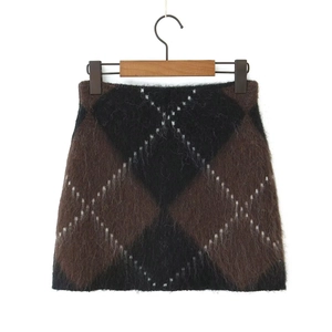 Detail of plush brown and black argyle knit skirt texture on a wooden hanger