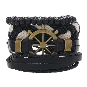 Close-up of multilayer leather bracelet set with vintage bronze helm and woven beads