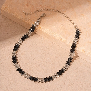 Detail of black and white rhinestone choker with geometric weave and adjustable clasp