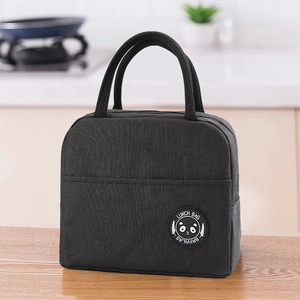 Detail of black insulated lunch bag featuring reinforced handles and front pocket