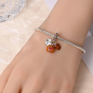 Detail of S925 silver charm bracelet with 'Give Thanks' heart, pumpkin, and autumn leaf charms