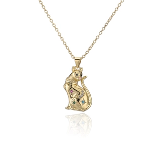 Macro detail of gold-plated tiger pendant with colorful crystals and star-moon motifs
