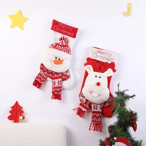 Large knitted Christmas stockings featuring snowman and reindeer designs with festive decor