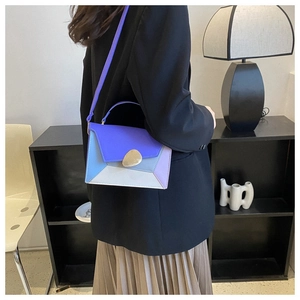 Detail of color-block crossbody bag with geometric stitching and metal buckle closure