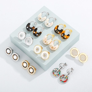 Chic gold stainless steel hollow earrings set with rhinestones and marble resin motifs