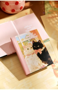 Close-up of A7 notebook featuring cute fluffy cat illustration and 'Puff Meow' text.