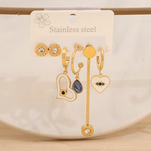 Detail of gold clover stud earrings set in stainless steel with Roman numeral engraving