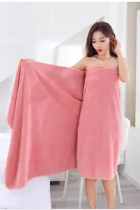 Detailed texture of pink coral fleece wearable bath towel with waffle weave pattern