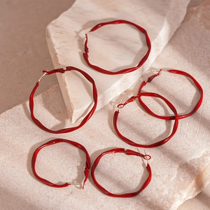 Minimalist red wave textured geometric hoop earrings on a natural stone base
