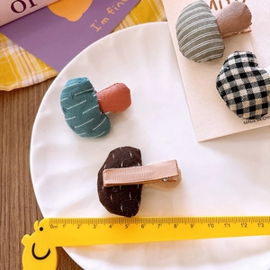 Handmade mushroom fabric hair clips in plaid and polka dot patterns for girls