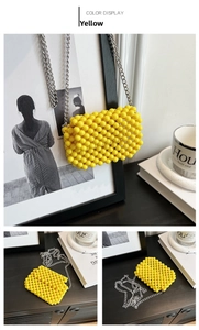 Detail of yellow beaded crossbody bag with textured sphere beads and silver metal chain