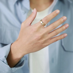Three-tone interwoven stainless steel ring in gold, rose gold, and silver finishes