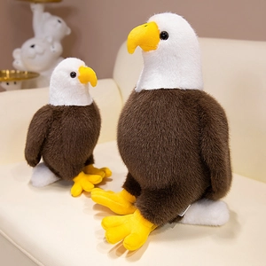 Realistic bald eagle plush set with soft white head and brown body on a leather sofa