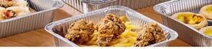 Aluminum foil containers for air fryers filled with fried chicken and snacks on wood
