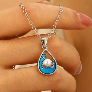 Silver ocean wave sun necklace with blue enamel droplet pendant and white pearl