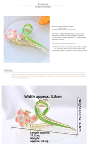Detailed view of alloy flower shark hair clip with green vines and white pearls