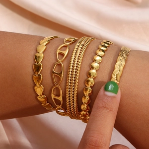 Close-up of a five-piece set of 18K gold plated adjustable bracelets with heart and link designs