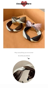 Macro detail of elegant satin twisted knot headband with bicolor contrast fabric