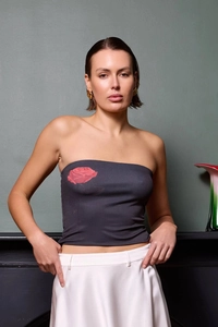 Close-up of a charcoal grey tube top featuring a vibrant red rose floral print detail