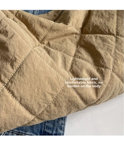 Detail of khaki quilted fabric with diamond stitching and lightweight texture on tote bag