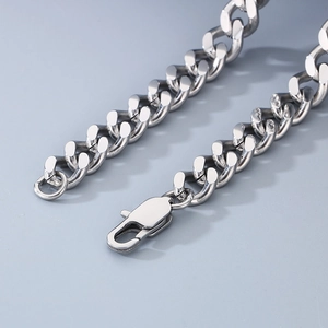 Close-up of a silver chunky Cuban link chain with a high-polish finish and lobster clasp