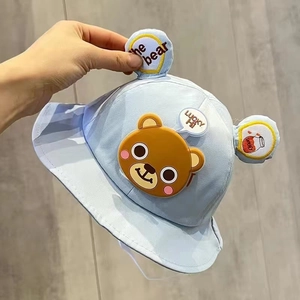 Detail of light blue baby bucket hat with cute bear ears and embroidered cartoon patch