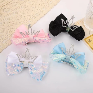 Sparkly sequin bow hair clips with crown detail in pink, black, white, and blue colors