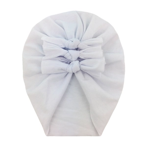Close-up of soft baby cotton turban hat featuring three knots and knit texture details