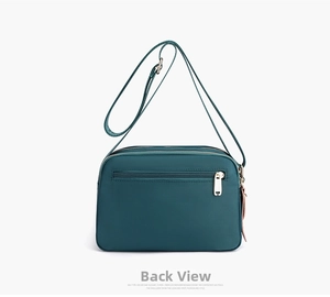 Rear view of dark green water-resistant nylon crossbody bag with zipper pocket