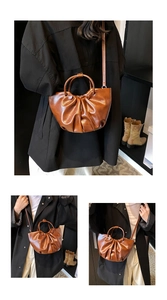 Detail shot of a brown pleated cloud bag showing the soft faux leather texture and styling