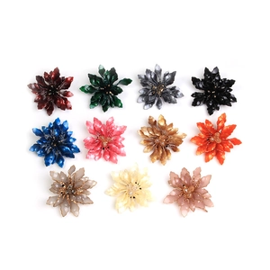 Detailed grid view of elegant acrylic floral brooches in eleven vibrant multi-color options