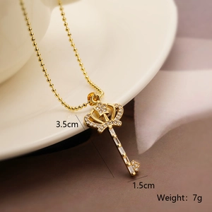 Detail view of 18k gold plated crown key pendant necklace with size and weight specs
