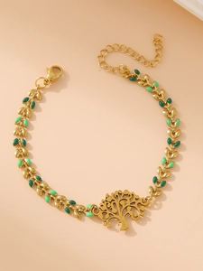 Detail of golden tree of life bracelet with green enamel leaf chain and lobster clasp