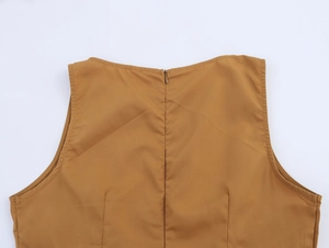 Detail of hidden zipper and waist seams on mustard yellow coconut tree embroidered dress