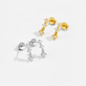 Macro shot of S925 sterling silver stud earrings with zircon stones in gold and silver