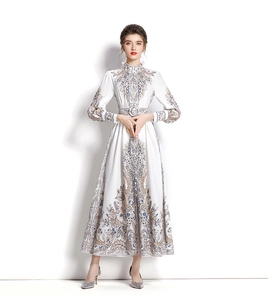 Detail of elegant white long-sleeve dress with vintage print and matching waist belt