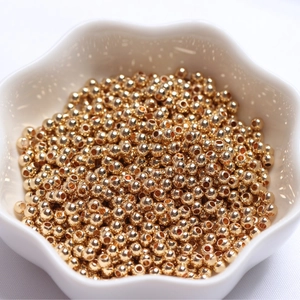 Polished 14k gold-filled solid round spacer beads in a star-shaped ceramic bowl