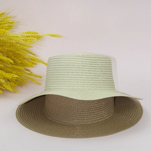 Detail of glittery straw hat weave texture in beige and brown with golden wheat accents
